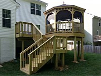 <b>Wood deck and stairs with wood railing and screened in wood gazebo</b>